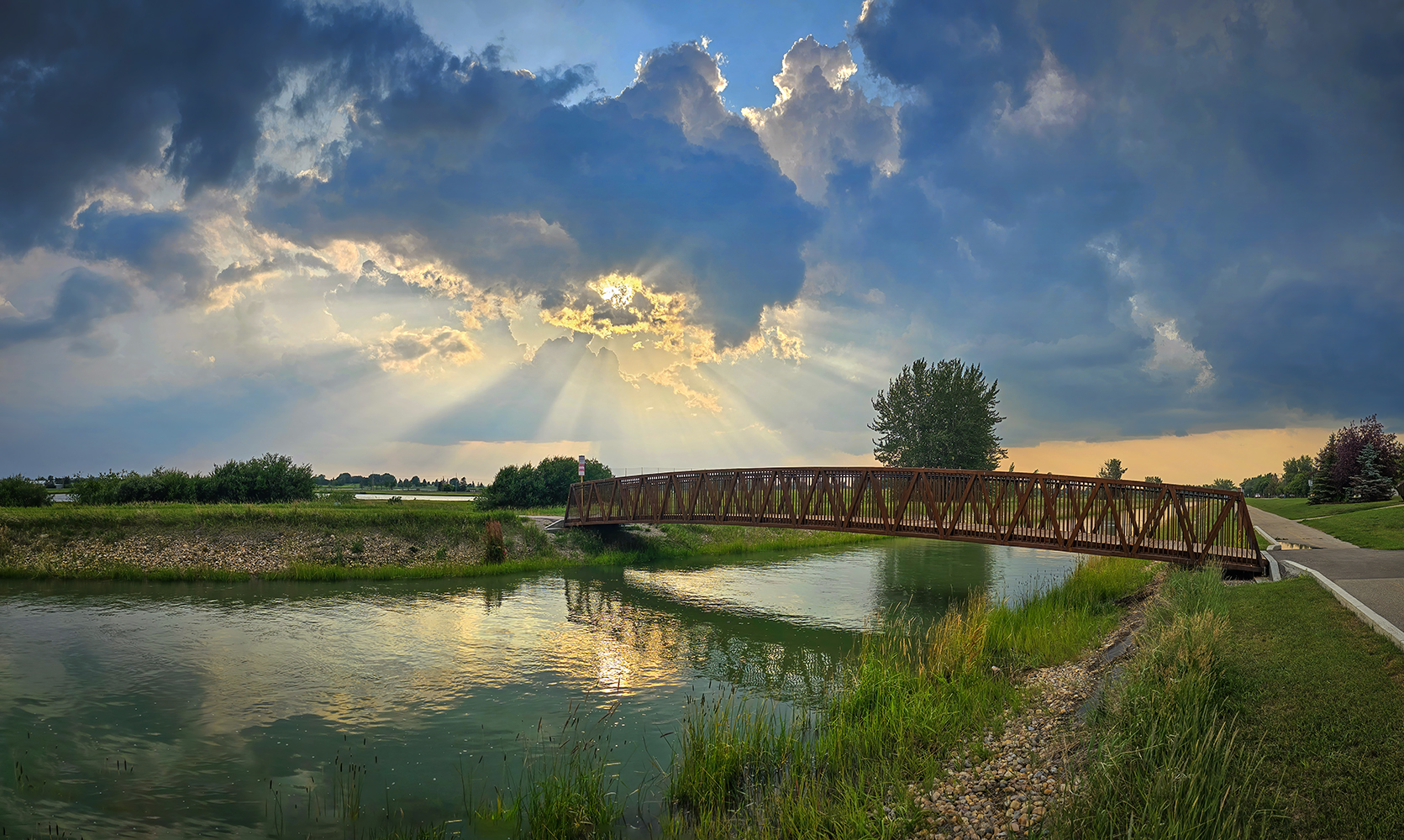 Crepuscular rays viewed from Tom Sadler Bridge, Strathmore, Alberta. 2023-07-07