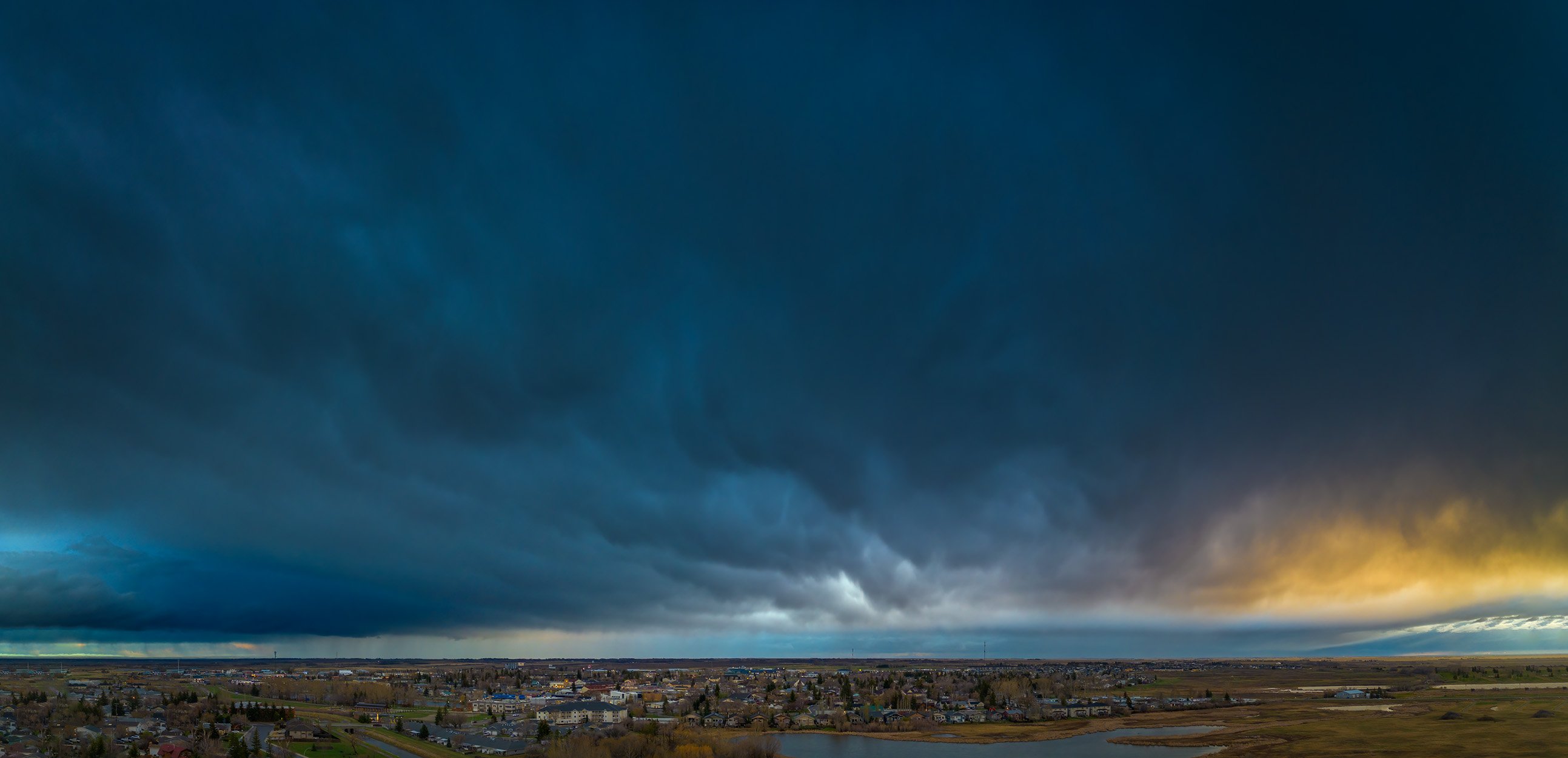Here comes the rain again, Thomas Drive looking East, Strathmore, AB, 2025-04-29
