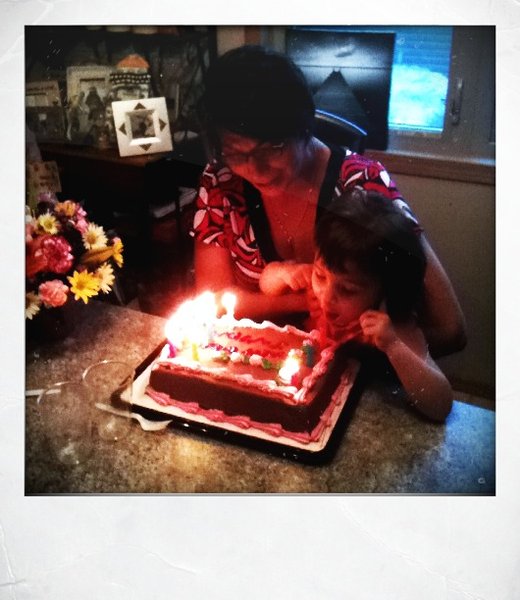 Janelle and Sam blowing out candles.