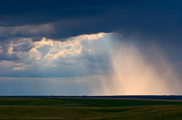 Illuminati: The Sun Breaks Through A Downpour East of Sedalia, Alberta