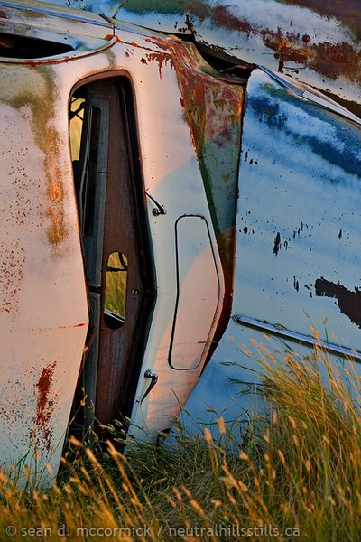 Parallel parked: Old car on side in pasture