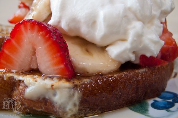 French toast topped with bananas, strawberries, and whipped cream