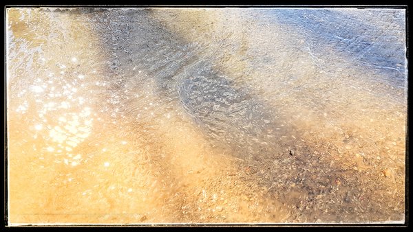 Melt water crossing walking path