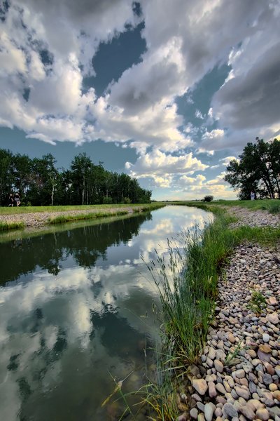 Clouds Reflected in Irrigation Canal Northwest of Strathmore, Alberta, June 16, 2021, 1 of 2