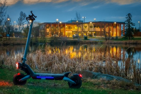 Scooter Against Municipal Building, Gray Park, Strathmore, Alberta. 2023-05-03