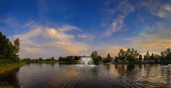 Fountain viewed looking NE at dusk, Kinsmen Park, Strathmore, Alberta, 2023-07-20