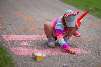 Youngster drawing flag in chalk, Canada Day, Kinsmen Park, Strathmore, AB, 2026-07-01