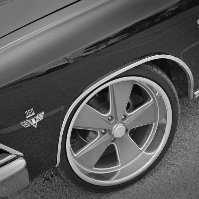 Black and white close-up of a classic Chevrolet El Camino SS parked on asphalt. The shot highlights the front left fender with "350 V8" and "SS" badges, chrome trim, and a large custom five-spoke wheel.